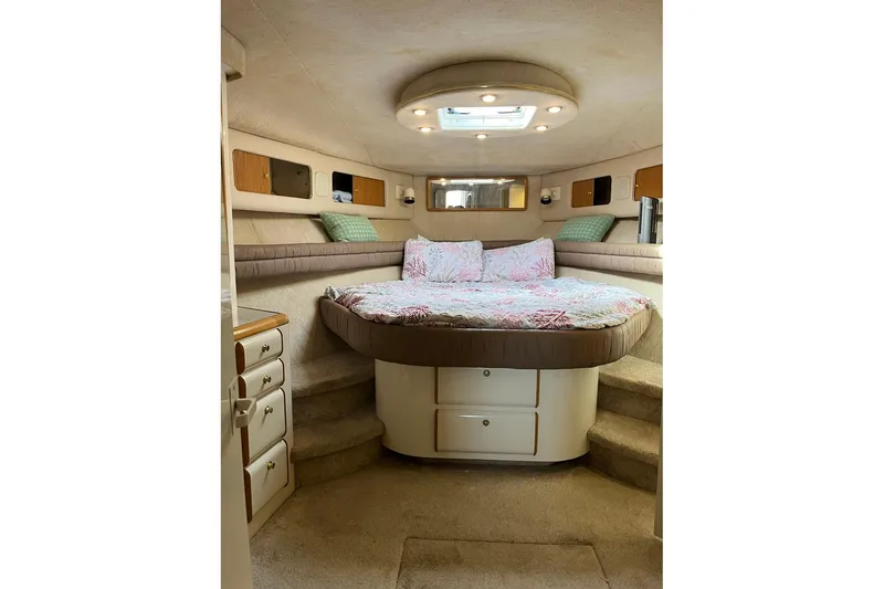 Slide: The Image of Interior of 1996 Sea Ray 500 Sedan Bridge with cozy bed and storage cabinets. - 7