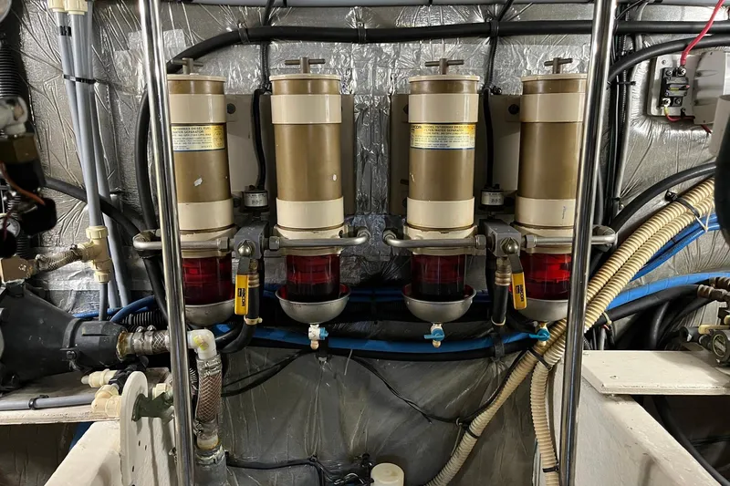 Slide: The Image of Engine room of 1996 Sea Ray 500 Sedan Bridge with fuel filters and hoses. - 16