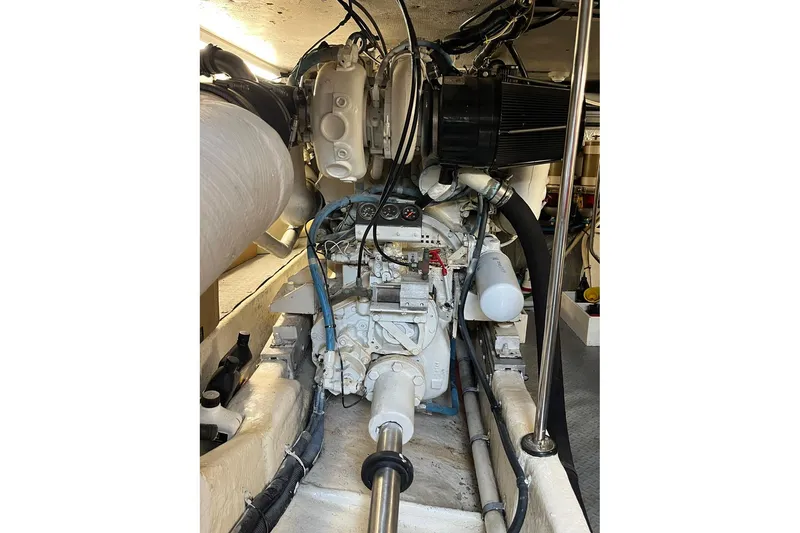 Slide: The Image of Engine room of a 1996 Sea Ray 500 Sedan Bridge, showcasing mechanical components and wiring. - 15