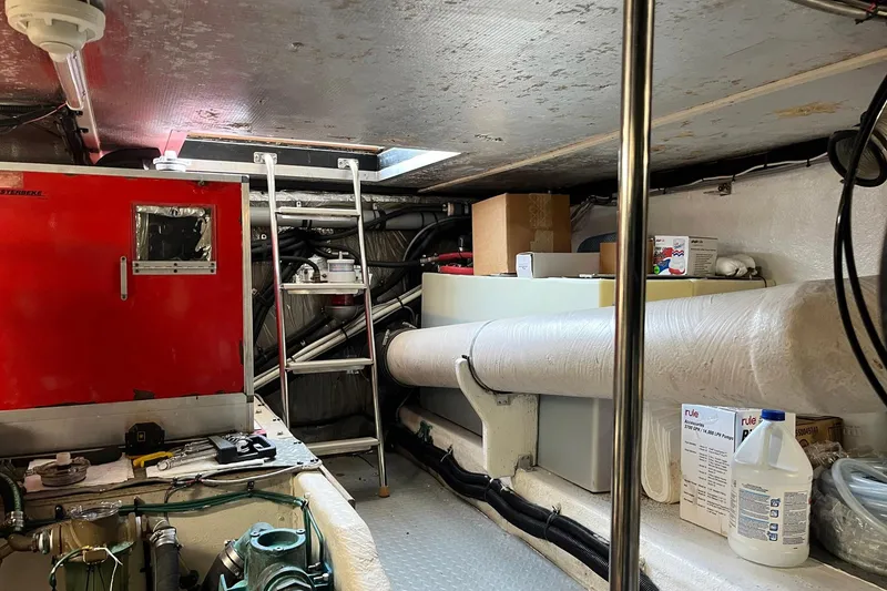 Slide: The Image of Engine room of 1996 Sea Ray 500 Sedan Bridge with equipment and storage. - 17