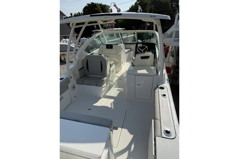 Slide: The Image of 2027 Pursuit DC 266 Dual Console boat interior with seating and helm, showcasing modern design. - 4