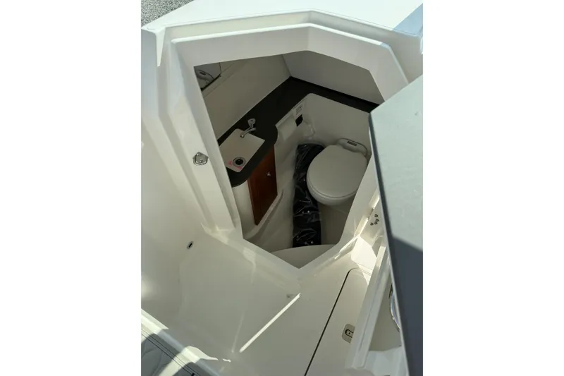 Slide: The Image of Interior view of 2027 Pursuit DC 266 Dual Console boat's compact bathroom. - 8