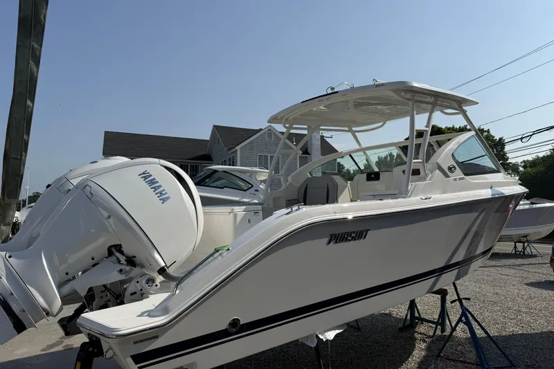 Slide: The Image of 2027 Pursuit DC 266 Dual Console boat with Yamaha engine on display. - 3