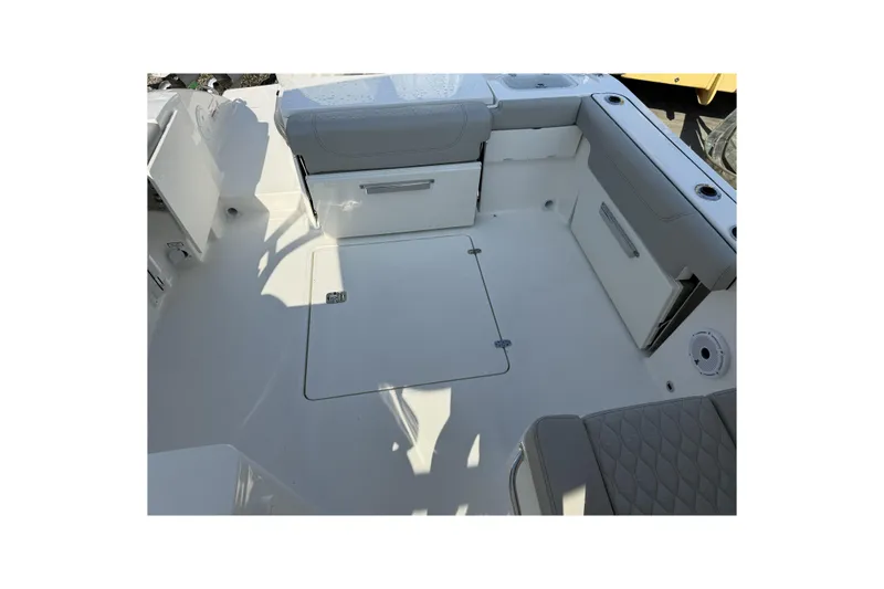 Slide: The Image of 2027 Pursuit DC 266 Dual Console boat interior with seating and storage compartments. - 7