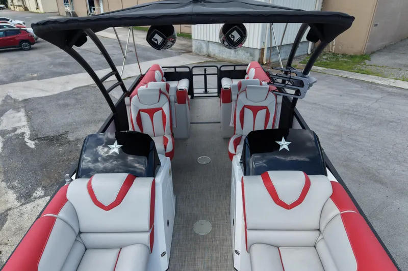 Slide: The Image of 2020 Monterra Surf boat interior with red and white seating, black canopy, and star accents. - 18