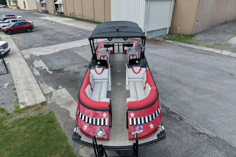 Slide: The Image of Aerial view of 2020 Monterra Surf boat with red and white seating, parked in an industrial area. - 3