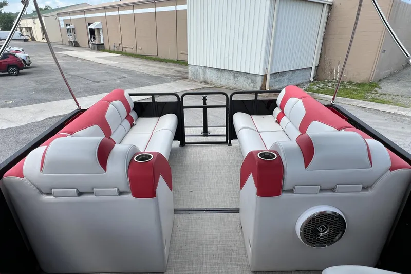 Slide: The Image of 2020 Monterra Surf boat interior with red and white seating, cup holders, and speaker. - 13