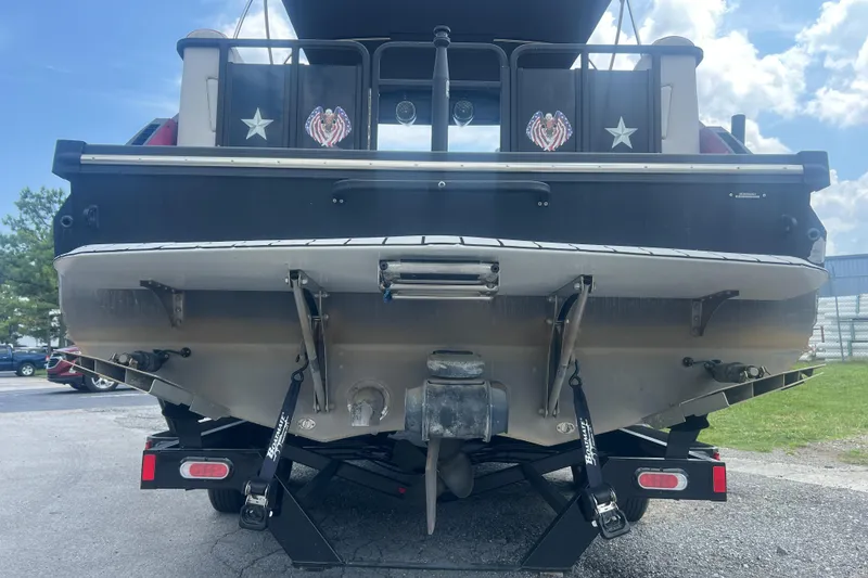 Slide: The Image of Rear view of a 2020 Monterra Surf boat on a trailer under a blue sky. - 20