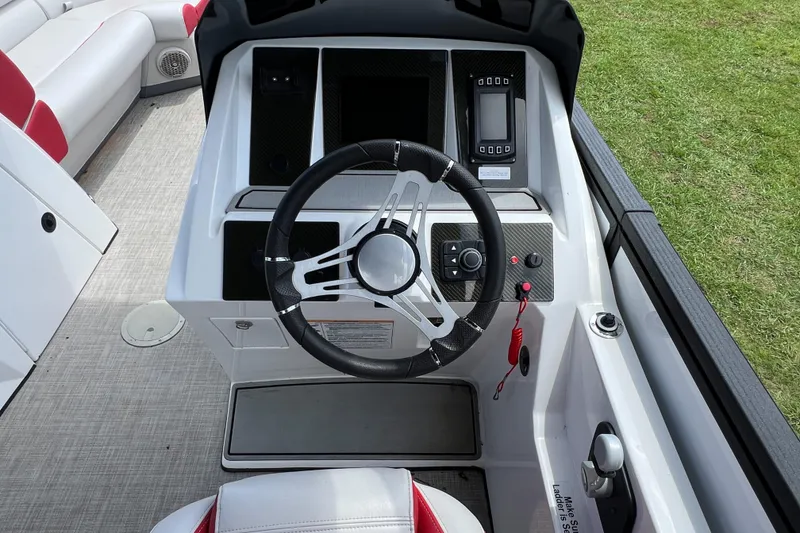 Slide: The Image of Steering console of a 2020 Monterra Surf boat with modern controls and seating. - 11