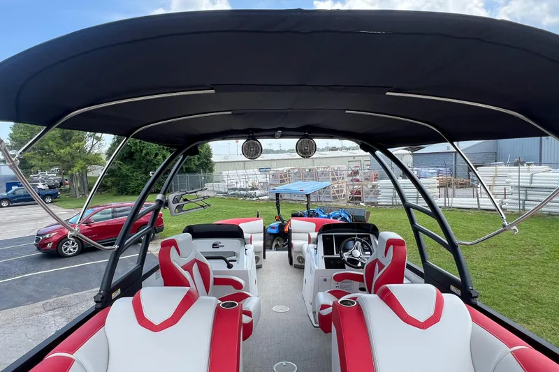 Slide: The Image of Interior view of 2020 Monterra Surf boat with red and white seating under a canopy. - 19
