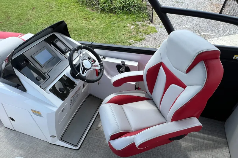 Slide: The Image of Captain's seat and control panel of a 2020 Monterra Surf boat, featuring modern navigation equipment. - 10