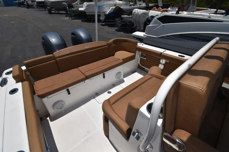 Slide: The Image of 2020 Sea Hunt Ultra 275 SE boat interior with tan seating and dual engines. - 10