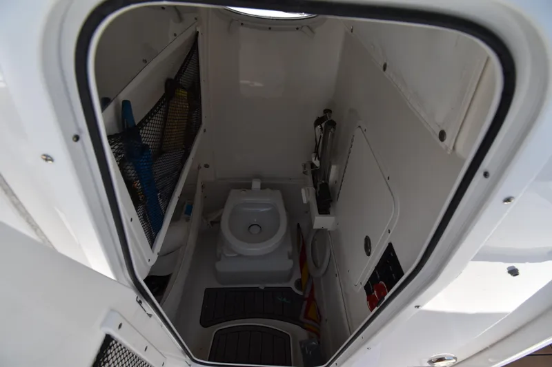 Slide: The Image of Interior view of 2020 Sea Hunt Ultra 275 SE boat's compact bathroom. - 20