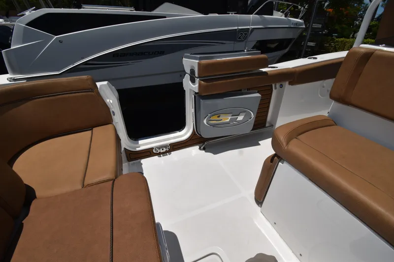 Slide: The Image of 2020 Sea Hunt Ultra 275 SE boat interior with brown seating and sleek design. - 17