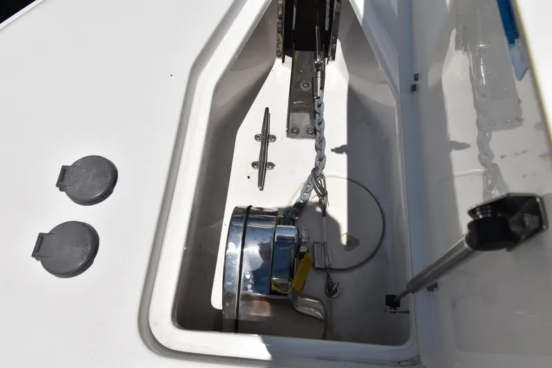 Slide: The Image of Anchor compartment of 2020 Sea Hunt Ultra 275 SE boat, featuring chain and winch. - 11