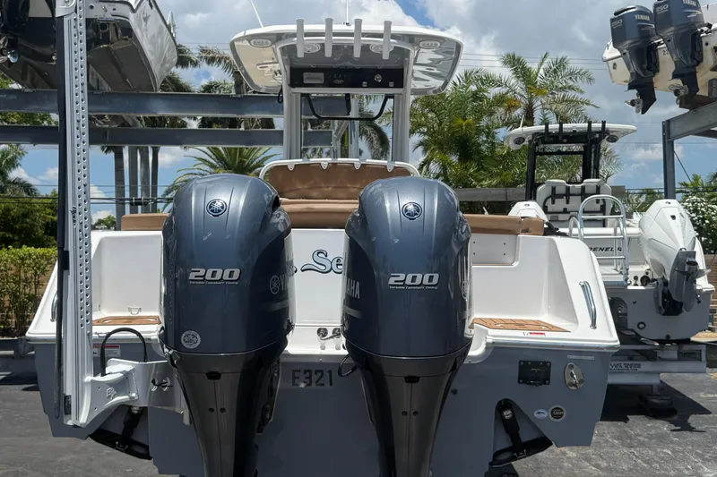 Slide: The Image of 2020 Sea Hunt Ultra 275 SE boat with dual Yamaha 200 engines, docked outdoors. - 3