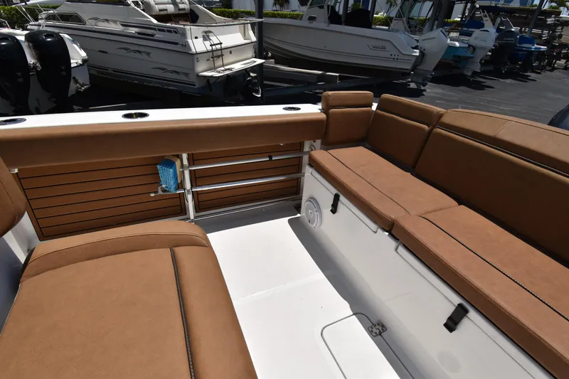 Slide: The Image of 2020 Sea Hunt Ultra 275 SE boat interior with brown seating and storage compartments. - 14