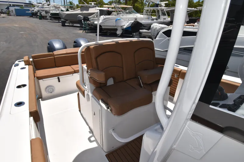 Slide: The Image of 2020 Sea Hunt Ultra 275 SE boat interior with brown seating and dual engines. - 12
