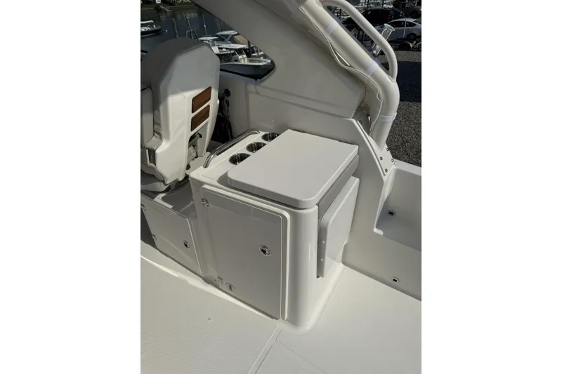Slide: The Image of 2027 Pursuit DC 286 Dual Console boat interior with seating and storage compartments. - 10