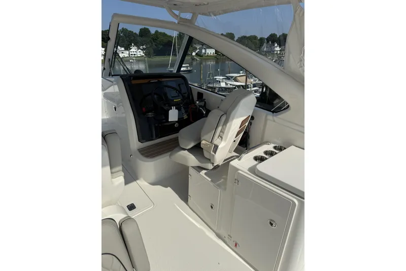Slide: The Image of 2027 Pursuit DC 286 Dual Console boat interior with helm and seating area. - 9