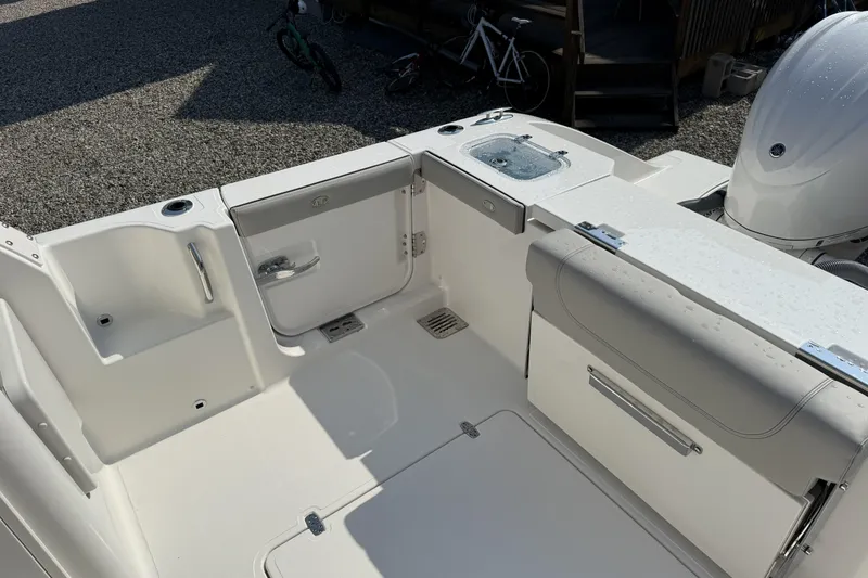 Slide: The Image of 2027 Pursuit DC 286 Dual Console boat interior with seating and storage features. - 7