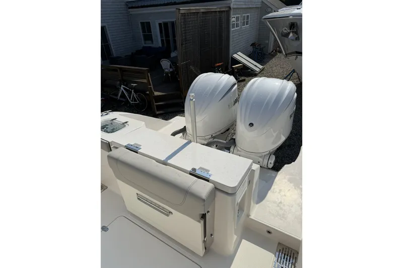 Slide: The Image of 2027 Pursuit DC 286 Dual Console boat with twin outboard engines. - 17