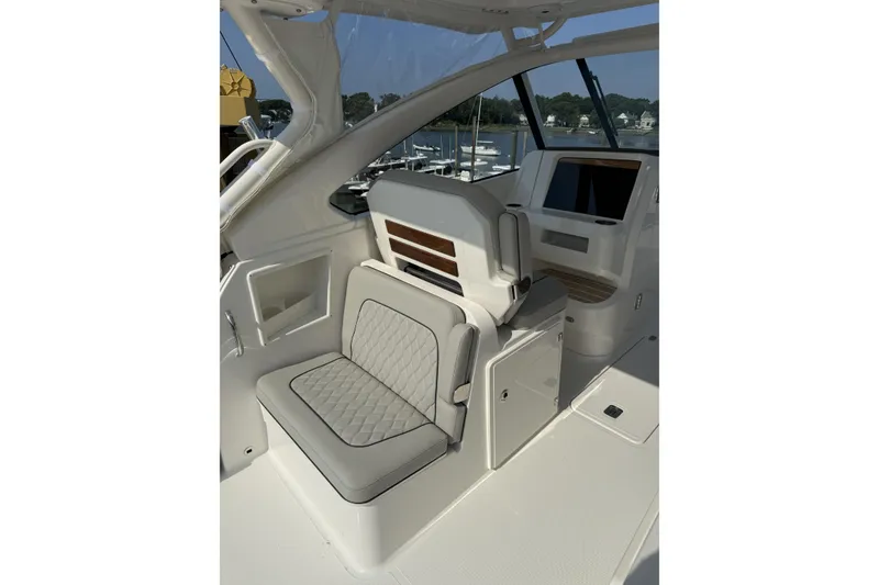 Slide: The Image of 2027 Pursuit DC 286 Dual Console boat interior with luxurious seating and modern dashboard. - 11