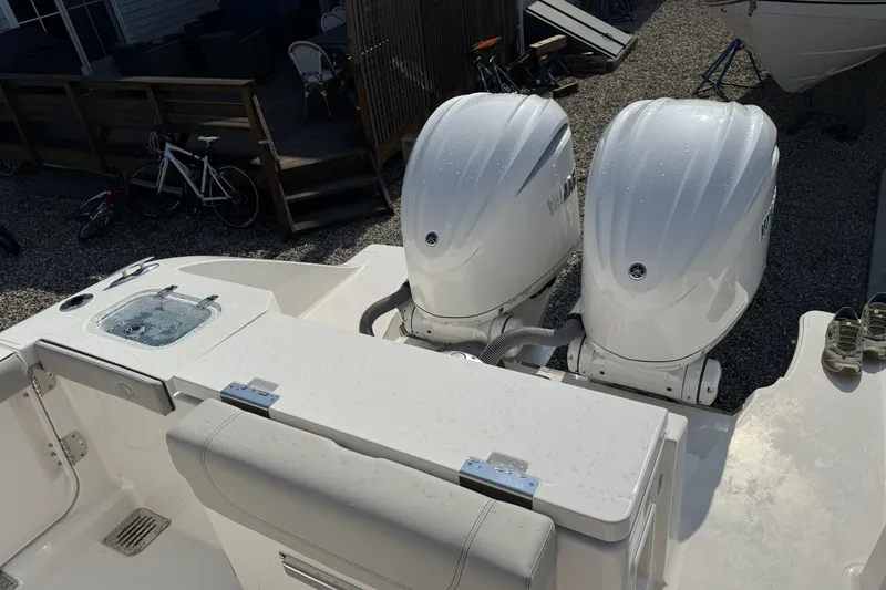 Slide: The Image of 2027 Pursuit DC 286 Dual Console boat with twin outboard engines, rear view. - 16