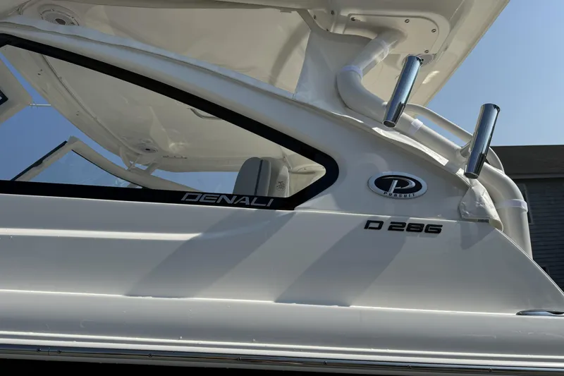 Slide: The Image of 2027 Pursuit DC 286 Dual Console boat, side view with Denali branding. - 4