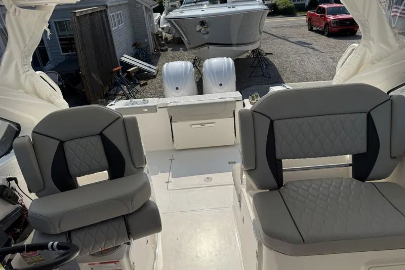 Slide: The Image of 2027 Pursuit DC 286 Dual Console boat interior with stylish seating and modern design. - 15