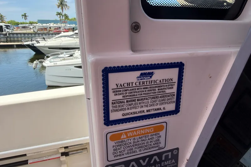 Slide: The Image of 2024 Navan C30 yacht certification label with safety warnings at a marina. - 37