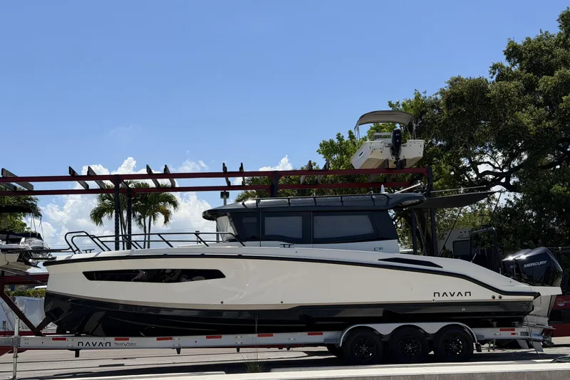 The Image of 2024 Navan C30 boat on trailer, parked outdoors under clear blue sky. - 1