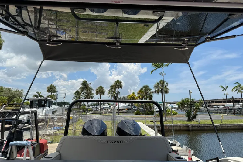 Slide: The Image of 2024 Navan C30 boat docked, featuring dual engines and a canopy, with palm trees in the background. - 39