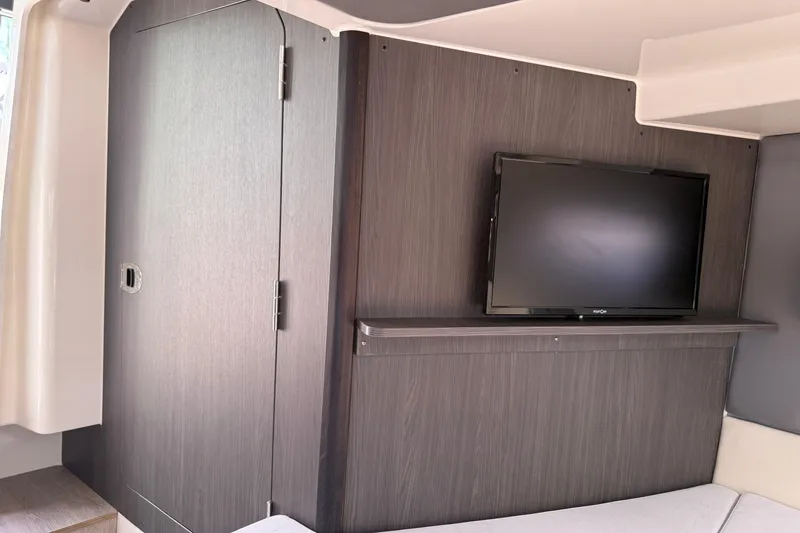 Slide: The Image of Interior of 2024 Navan C30 featuring a mounted flat-screen TV on a wooden panel. - 31