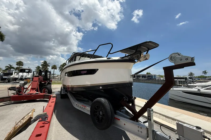Slide: The Image of 2024 Navan C30 boat on trailer at marina under cloudy sky. - 7