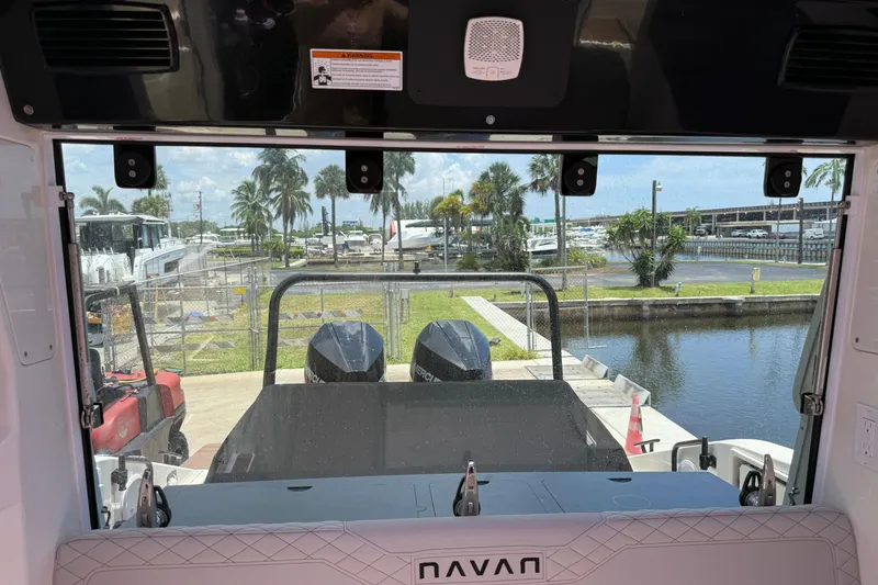 Slide: The Image of Interior view of 2024 Navan C30 boat overlooking marina with palm trees and water. - 9