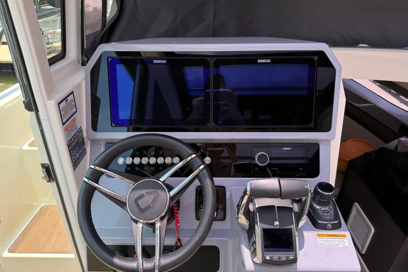 Slide: The Image of 2024 Navan C30 boat cockpit with dual Simrad displays and modern steering controls. - 35