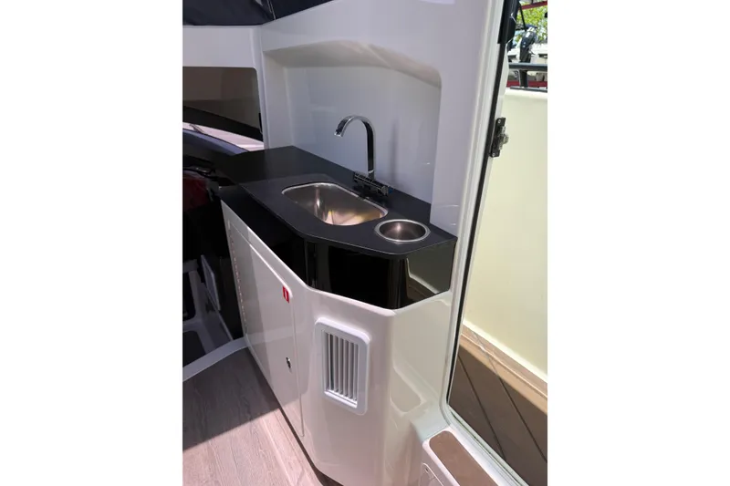 Slide: The Image of 2024 Navan C30 boat interior with sleek kitchenette, featuring a modern sink and faucet. - 12