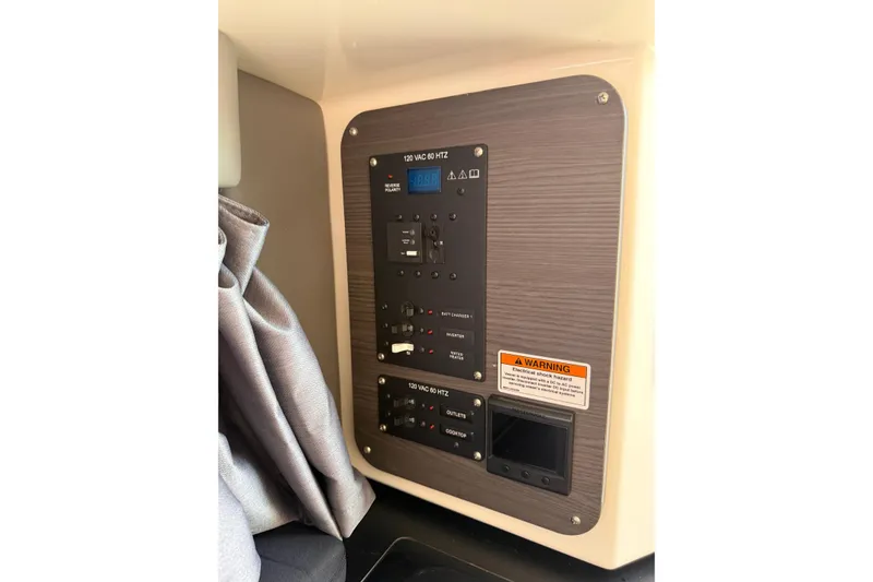 Slide: The Image of Electrical control panel in 2024 Navan C30 vehicle interior, featuring switches and warning label. - 20