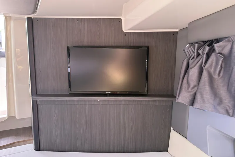 Slide: The Image of 2024 Navan C30 interior with mounted TV and modern wood paneling. - 27