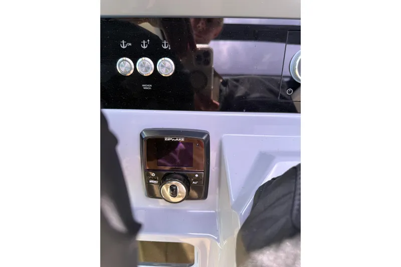 Slide: The Image of Control panel of 2024 Navan C30 boat featuring anchor winch and Zipwake system. - 19