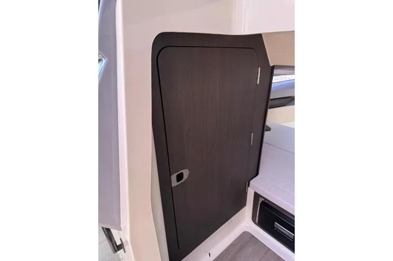 Slide: The Image of 2024 Navan C30 interior with sleek wooden cabinet door design. - 25