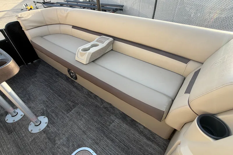 Slide: The Image of 2023 Godfrey Sweetwater 2286 C boat interior with beige seating and cup holders. - 20