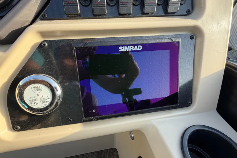 Slide: The Image of Dashboard of 2023 Godfrey Sweetwater 2286 C with Simrad display and control panel. - 16