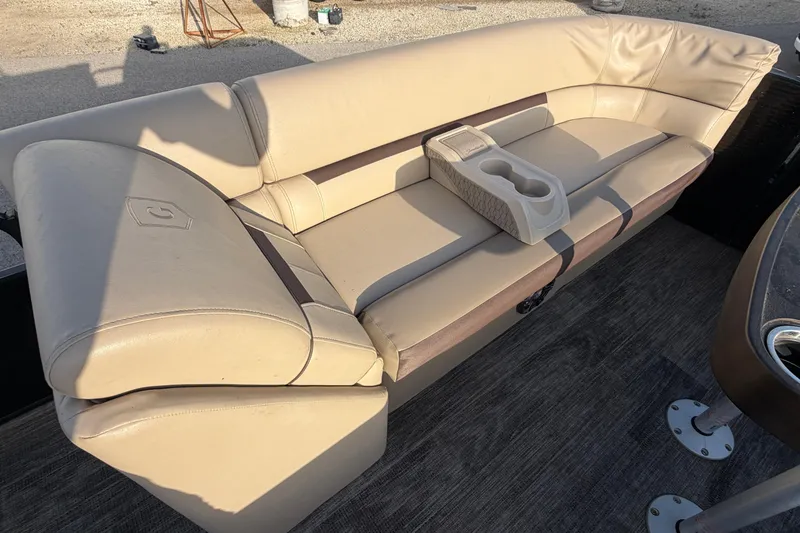 Slide: The Image of 2023 Godfrey Sweetwater 2286 C boat interior with beige seating and cup holders. - 22
