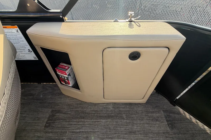 Slide: The Image of 2023 Godfrey Sweetwater 2286 C boat interior storage compartment with beige upholstery. - 6