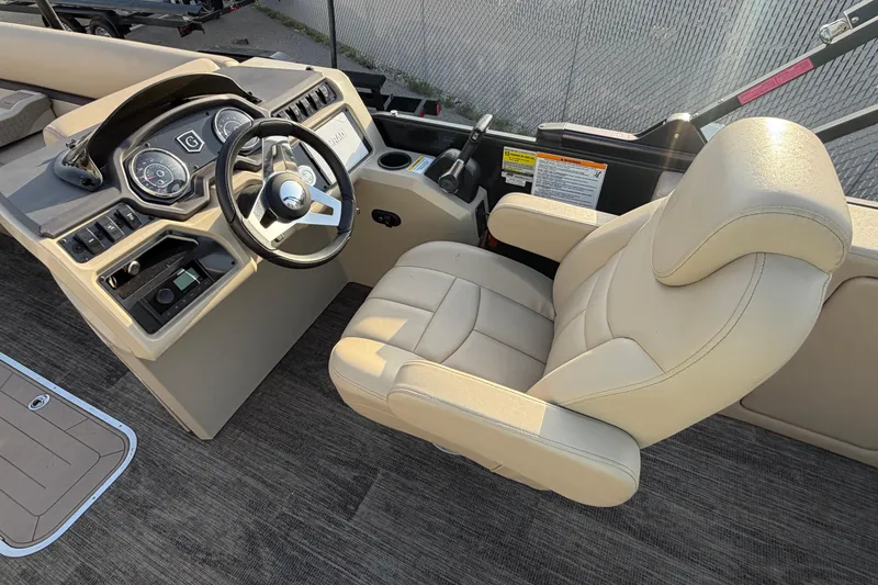 Slide: The Image of 2023 Godfrey Sweetwater 2286 C boat helm with beige captain's chair and control panel. - 11