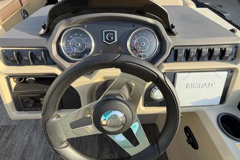 Slide: The Image of Steering console of 2023 Godfrey Sweetwater 2286 C boat with gauges and controls. - 14