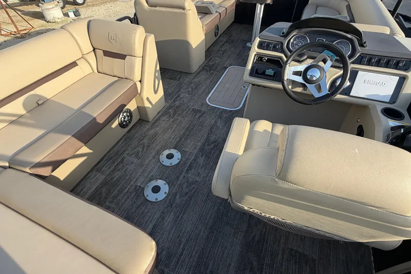 Slide: The Image of 2023 Godfrey Sweetwater 2286 C pontoon boat interior with beige seating and modern dashboard. - 10