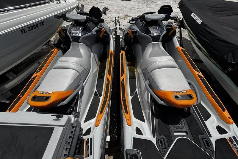 Slide: The Image of Two 2023 Sea-Doo FishPro Trophy jet skis with orange accents, parked side by side. - 9